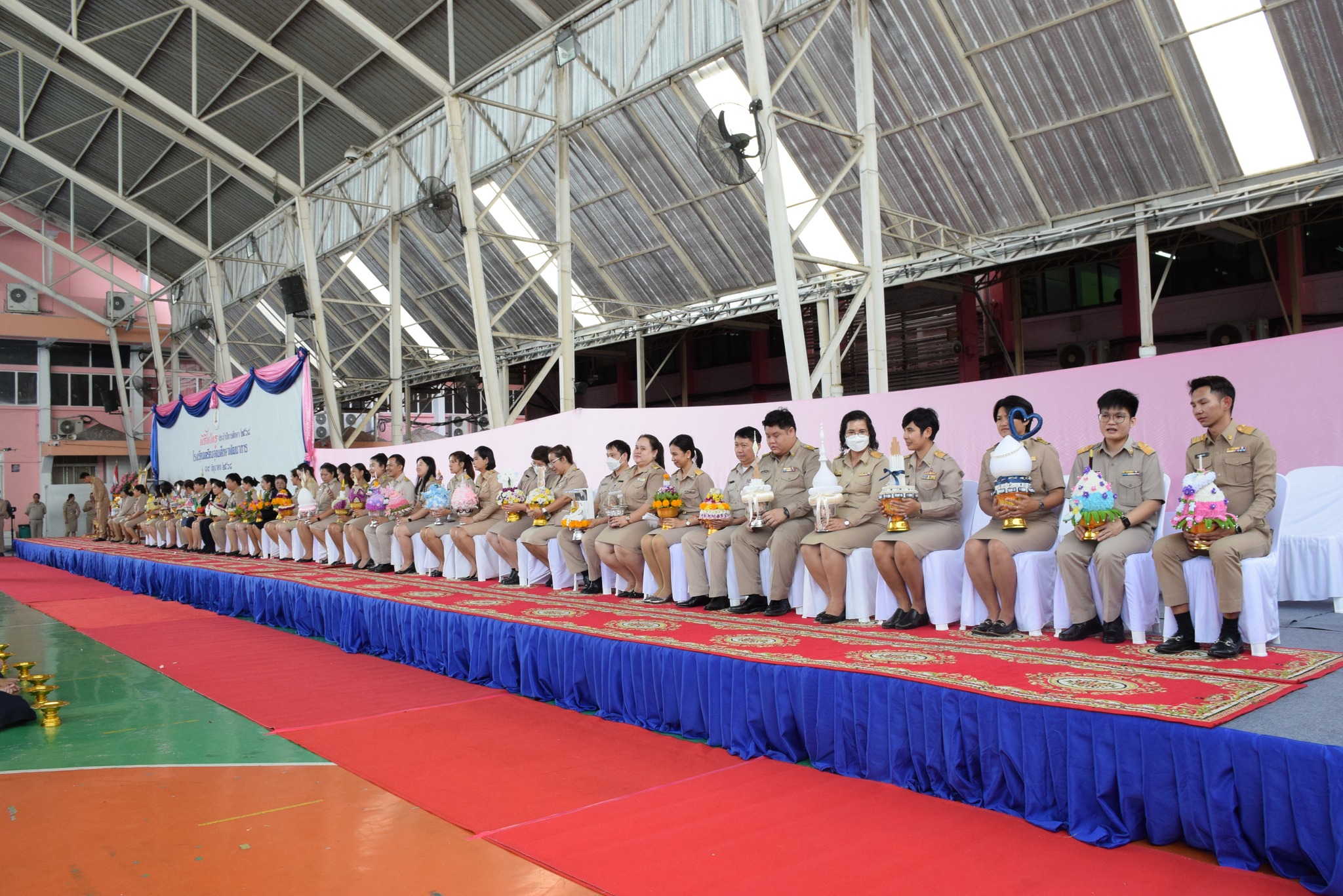 Students presenting Phan Wai Khru trays to teachers during Wai Khru Day ceremony